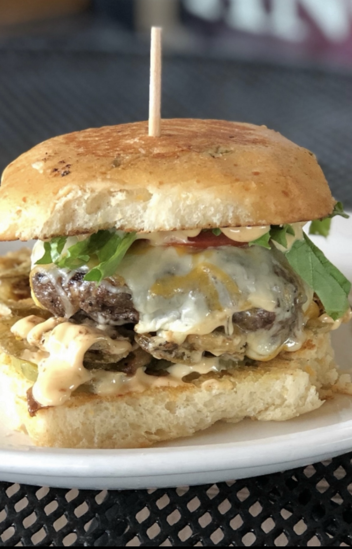 A towering cheeseburger on a jalapeño bun with chipotle mayo